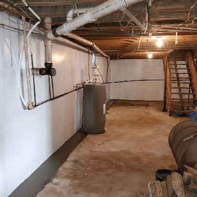 a basement with pipes and a tank