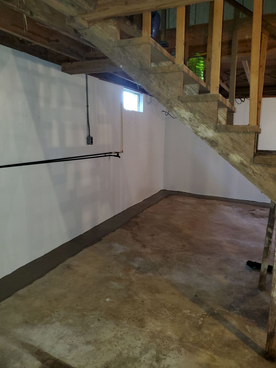 a basement with a wooden staircase